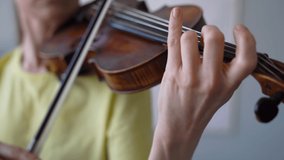 Handheld Close-up of Female Hands Playing Violin.  Finger Strike in violin. Violin Techniques - String Crossing. 