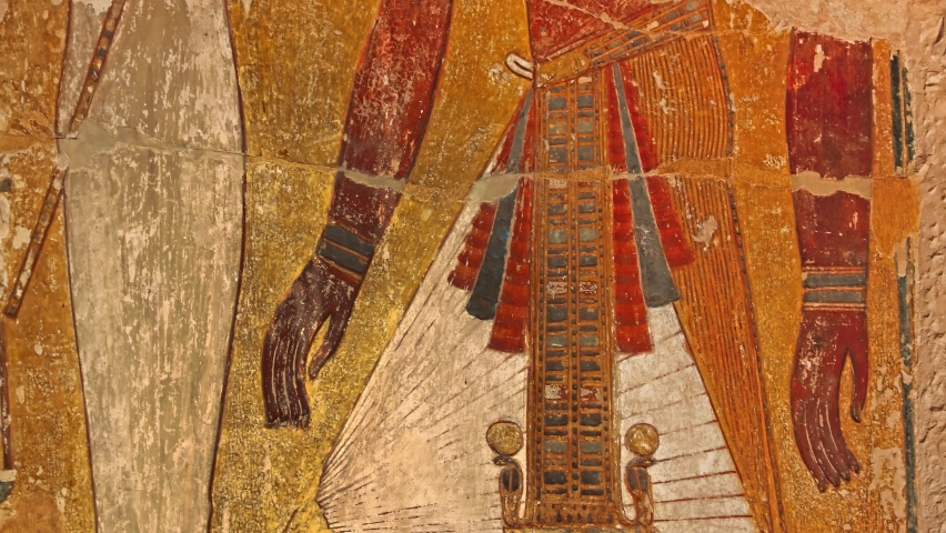 Close up background of antique stone wall with ancient Egyptian fresco painting of pharaoh and queen, tilt, front view