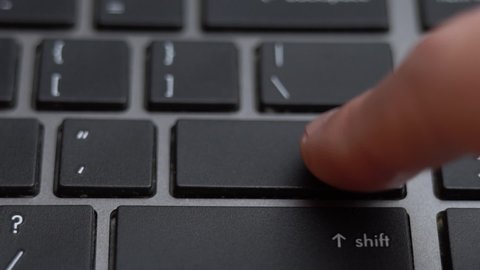 Enter button pressing on keyboard, laptop keyboard close up