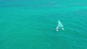 Scenery picturesque boat with sail in the ocean on nature background. 4K Aerial UHD Video Clip