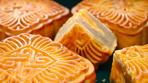 angle view square shape traditional mooncakes with a piece cut out rotating