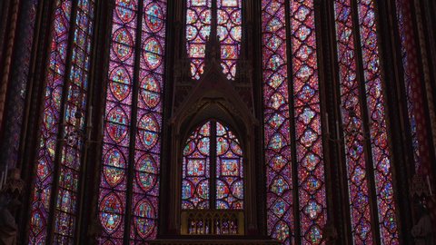 Paris, France - June 03 2021: Stained Glass Windows in Sainte Chapelle, Tilt up over the apse of the upper chapel