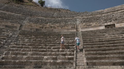 AMMAN, JORDAN - CIRCA 2021: Ancient Roman theatre in the capital of Jordan. Spectators take seats in the theater.