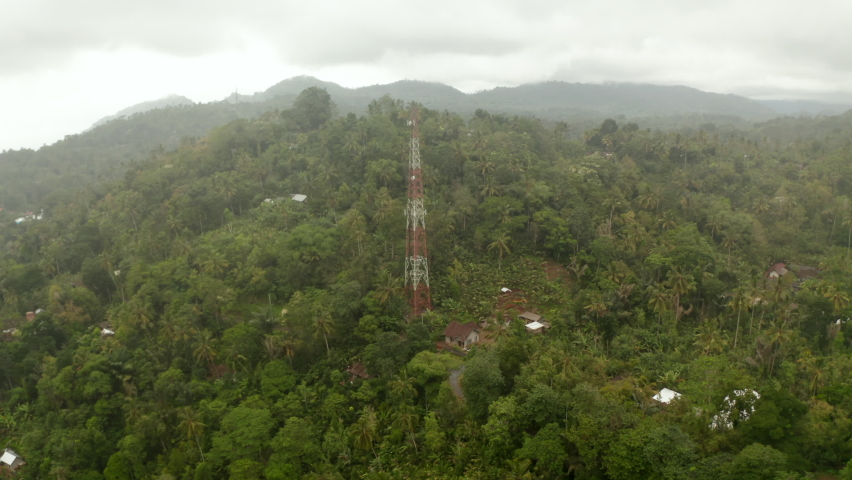 Close up aerial view of broadcast radio tower in the jungle. Wireless communications infrastructure in the Bali rainforest