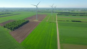 Aerial landscape with green fields and windmills.