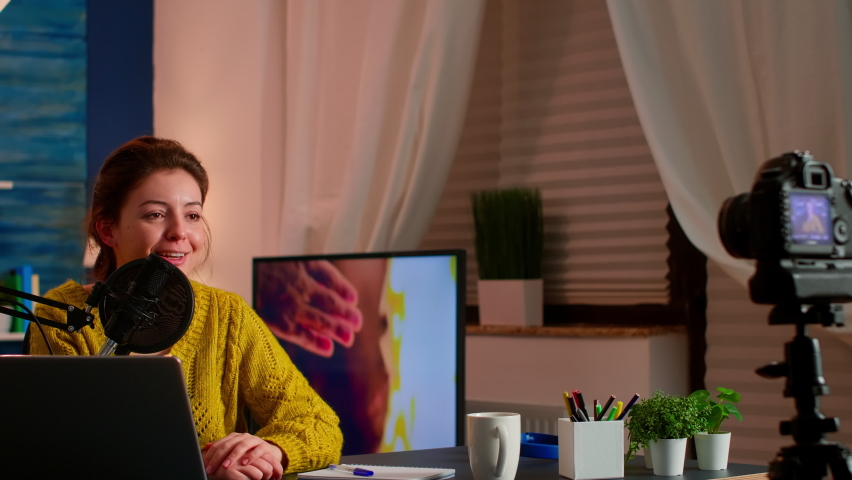 Influence vlogger talking and smiling during live streaming, broadcast with internet subscribers. Social media people , content maker, e-commerce concept. working from home podcast studio.