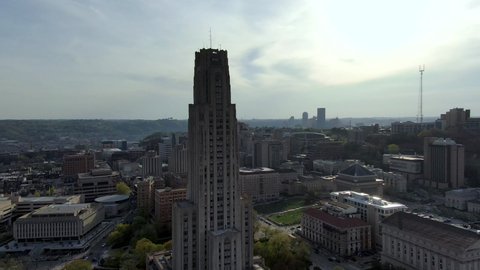 Descending aerial view of the Cathedral of Learning in Pittsburgh, Pennsylvania, famous tourist landmark, skyscraper dominating the skyline