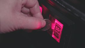 Multiple quarters inserted into coin mechanism arcade 4k - Powered by Shutterstock - Get 15% off with code: PIKWIZARD15