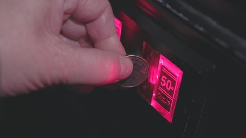 Multiple quarters inserted into coin mechanism arcade 4k