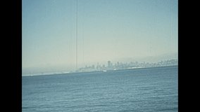 old San Francisco skyline from sea view of cruise boat. United States of America, Californian archival footage in 1970s.