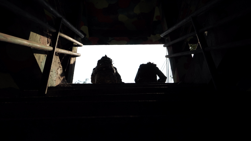 Women female soldier, Silhouettes of walking Two soldiers holding gun and carry bag in field with down the stairs in the container