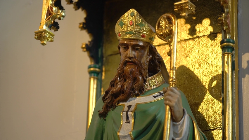 A Side View, Tilt-Up Video of a Statue of Saint Patrick inside a Catholic Church | Shutterstock HD Video #1073691818