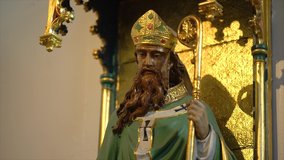 A Side View, Tilt-Up Video of a Statue of Saint Patrick inside a Catholic Church
