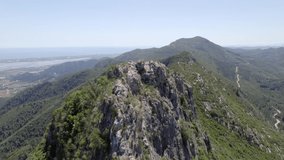 Drone flying over a mountain with the mediterranean sea at the background at May (spring) in La Murta mountain (Valencia, Spain).