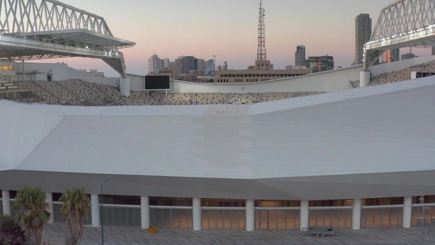 Aerial view over bloomfield stadium under construction, Israel
drone view at sunset of workers and empty stadium, Tel aviv, israel 
