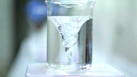 Twisting water in beaker by Spinning water vortex machine