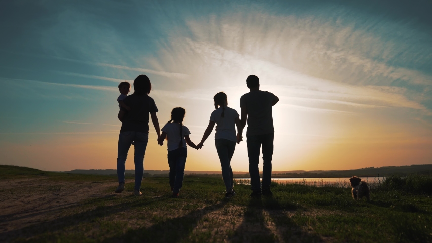 Happy family. Hiking in park. Happy cute family walking in nature park by lake. Parents with children walking. Family picnic by lake. Hiking in natural park. Children walk with their parents. Dog pets | Shutterstock HD Video #1073714969