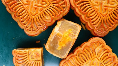top view square shape traditional mooncakes with one piece cut out rotating