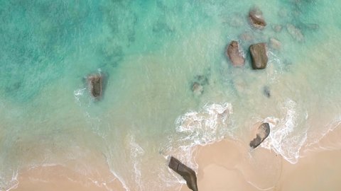 Seychelles sunset beach drone video, ocean and waves on an island in the tropics.