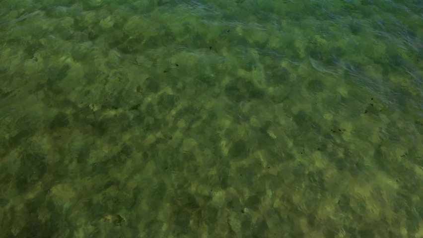 Drone shoot over Tota lake Boyaca Colombia, water over the lake and flight into the lake.