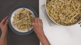 Delicious homemade Pasta with chicken, mushrooms, and Alfredo sauce, close up video,flat lay