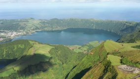 Miradouro do Cerrado das Freiras, Sao Miguel, Azores, Portugal. Panoramas of beautiful landscapes and lagoons. People enjoy rich natural beauties while skydiving. High quality 4k footage