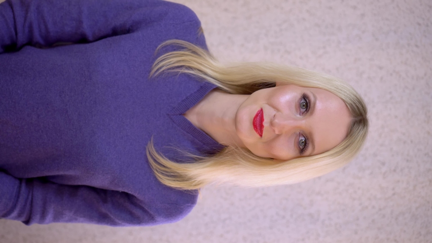 Beautiful female face with evening makeup, posing for the camera. She looks away and looks away. The blonde. An actress or singer with makeup at the Eurovision Song Contest.