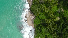 Phuket, Thailand. Professional Video. Aerial view shot. Drone camera over white beach sand and sew water clear. Nature video view of beautiful tropical beach and yacht at sea. On 5 June 2021.