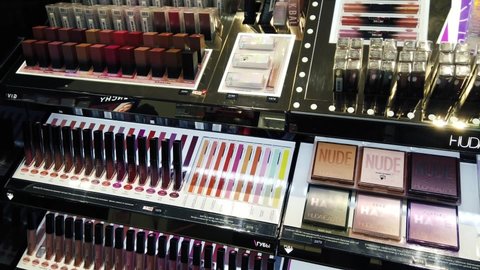 Decorative cosmetics samples and testers. Women makeup cosmetic products and perfume in beauty shop. Show cases with lipsticks, eyeshadows, perfume. Perm,Russia, 11-April,2021.