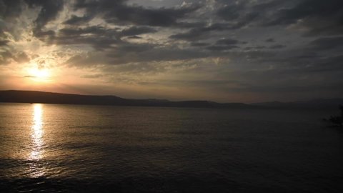 Sunset over the Sea of Galilee and Golan Heights. Lake Tiberias, Kinneret, Kinnereth.Heights. Panoramic View with dramatic sky and clouds. Full HD footage