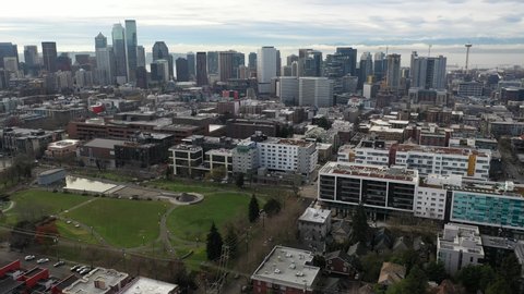 Afternoon aerial trucking footage of Cal Anderson Park, Capitol Hill, Pike - Pine, Cascade, Denny Triangle, Seattle Center, upscale, affluent neighborhoods uptown in Seattle, Washington