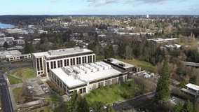 Aerial - drone footage of the Washington State Department of Enterprise Services building and capitol building campus area and offices in the center of Olympia, Washington.