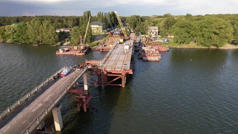 4K Repair of a bridge over the Sula river in Ukraine, Poltava region: Top view construction new bridge over the river work.