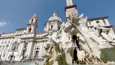 The fountain of the four rivers with the facade of the church of Santa Agnese in Piazza Navona in Rome. Town square. Baroque art. Tourism and travel