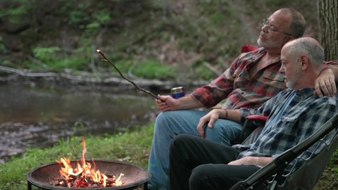 Male Gay Couple On Autumn Camping Trip in front of campfire स्टॉक वीडियो