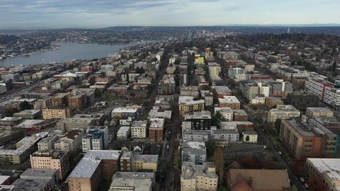 Cinematic aerial - drone trucking footage of Capitol Hill, Pike - Pine, First Hill, South Lake Union, Eastlake, Northlake, downtown with skyscrapers in the morning in King County, Washington State