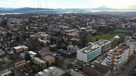 Cinematic aerial - drone dolly shot of Capitol Hill, Pike - Pine, First Hill, Cherry Hill, Squire Park Minor, Atlantic, downtown Seattle with Mt Rainier in the morning in King County, Washington