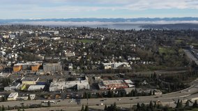 Cinematic aerial drone footage of Judkins Park, Atlantic, Leschi, I-90 freeway, Lake Washington, Mercer Island, commercial and residential buildings near downtown Seattle, Washington