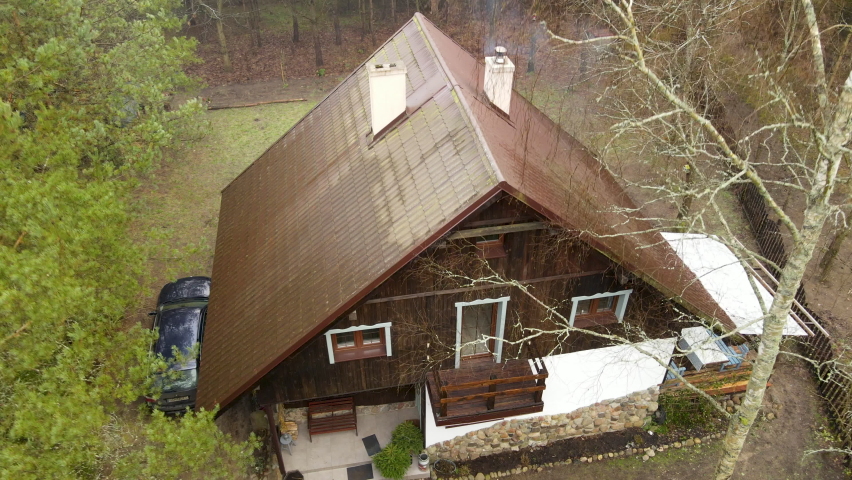 Rustic Wooden Cabin Deep In Forest Near Bartoszylas, Poland. - aerial descend