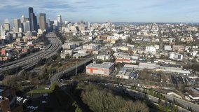 Cinematic aerial drone trucking footage of First Hill, Yesler Terrace, Atlantic, Cherry Hill, Squire Park, skyscrapers and high-rise commercial and residential buildings downtown Seattle, Washington