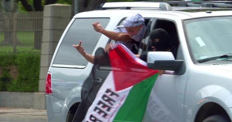 LOS ANGELES, CALIFORNIA, USA - MAY 16, 2021: Palestinian Hamas supporters at pro-Israel demonstration rally against Palestinian Hamas, a militant terrorist group governing Gaza, Los Angeles, 4K