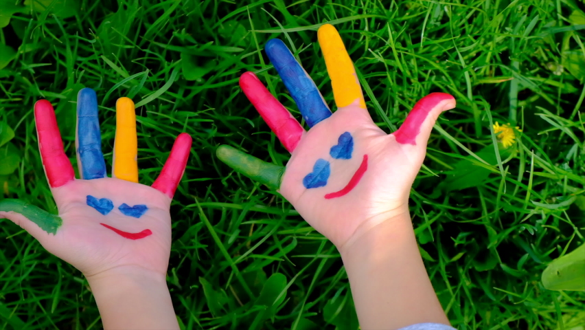 Child hand painted with paints. Selective focus.