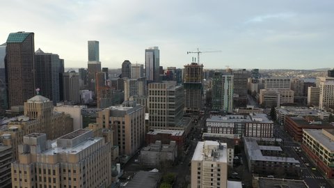 Cinematic aerial drone dolly footage of First Hill, Yesler Terrace, Atlantic, Cherry Hill, Squire Park, skyscrapers and high-rise commercial and residential buildings downtown Seattle, Washington