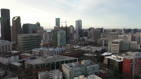 Cinematic aerial drone orbiting footage of First Hill, Yesler Terrace, Atlantic, Cherry Hill, Squire Park, skyscrapers and high-rise commercial and residential buildings downtown Seattle, Washington