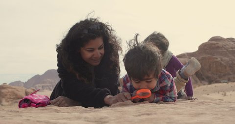 Mother playing with children in Wadi Rum Desert
