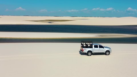 Lencois Maranhenses, Maranhao, Brazil - 06.01.2021 - Off road 4x4 vehicle on dunes and rainwater lagoons. Lençois Maranhenses, Maranhao, Brazil. Off road suv vehicle on dunes of Lencois Maranhenses.
