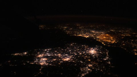 Time-lapse Video of Earth seen from the Space Station with dark sky and city lights at night over Romania to North Atlantic Ocean, Time Lapse 4K. Images courtesy of NASA. Pan up motion timelapse.