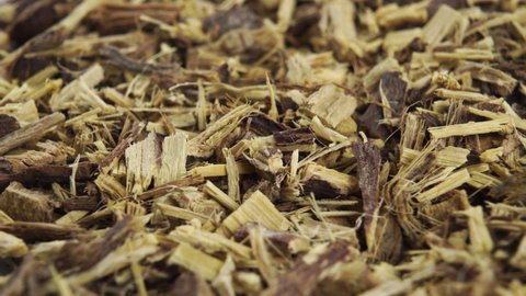 Chopped herbal licorice root rotates close-up. Macro. Alternative herbal medicine ingredient