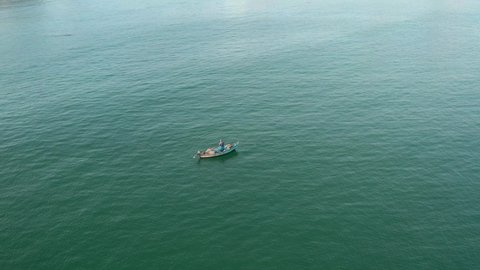 aerial view of isolated fisherman in a small trawler boat.