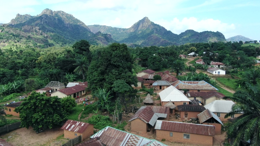 The remote settlement of Yashi, Nigeria in the Nasarawa State with an aerial view that includes rugged mountains Royalty-Free Stock Footage #1073813162